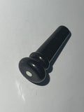 Black plastic guitar end pin button with white dot
