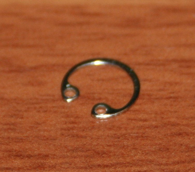 Amado waterkey cap retaining spring